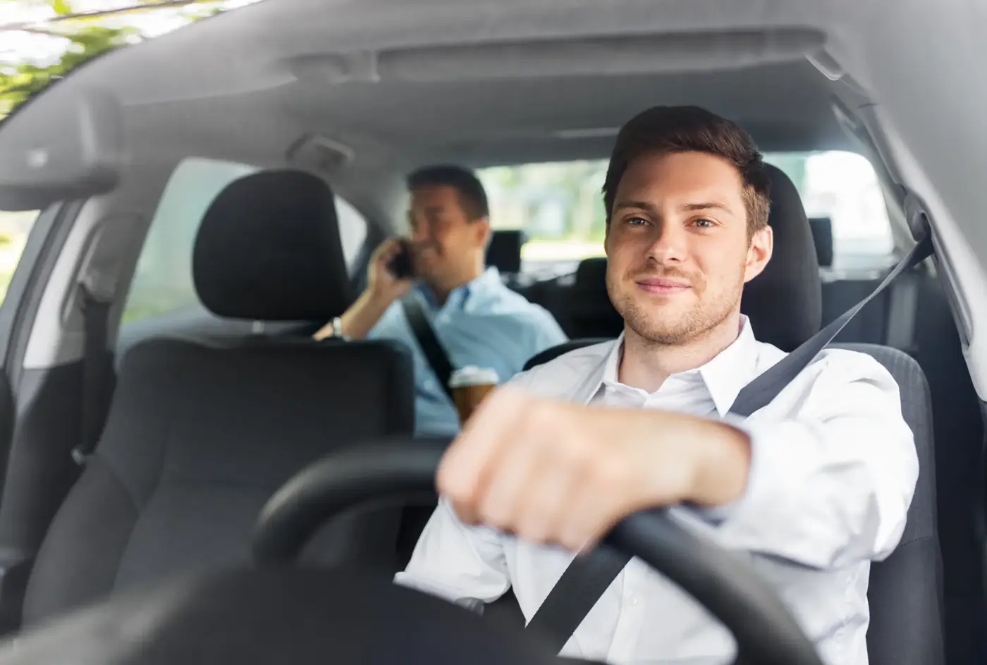 Driver and passenger belted in the cabin of a commercial vehicle during a working journey