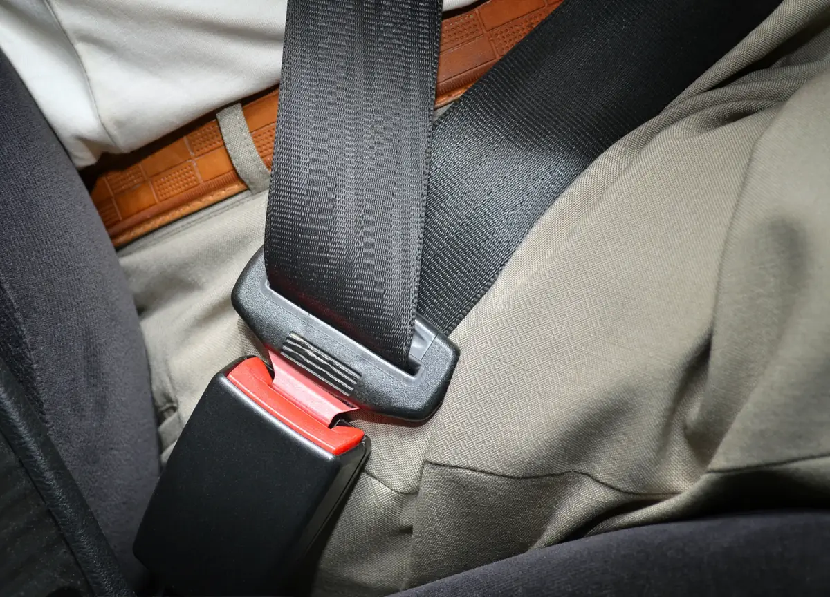 Seat belt fastened over an occupant seated in the rear of a vehicle